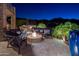 Outdoor patio with fire pit, comfortable seating, outdoor kitchen, and landscape lighting at 15054 E Sundown Dr, Fountain Hills, AZ 85268