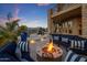 Comfortable outdoor patio with gas firepit, water feature, lounge seating, exterior bar and mountain views at 15054 E Sundown Dr, Fountain Hills, AZ 85268