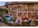 Outdoor living space with a pool, spa, fire pit, and comfortable seating areas at 15054 E Sundown Dr, Fountain Hills, AZ 85268