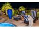 Charming patio with stylish striped chairs, guitar, a blue vase, and lush greenery, creating a serene outdoor retreat at 15054 E Sundown Dr, Fountain Hills, AZ 85268