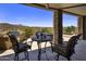Relax on the covered patio with stone columns, featuring outdoor seating, BBQ, and desert views at 15054 E Sundown Dr, Fountain Hills, AZ 85268