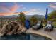Outdoor pool with rock waterfall feature, lounge chairs, patio umbrella and views of the mountains at 15054 E Sundown Dr, Fountain Hills, AZ 85268