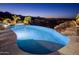 Inviting pool with integrated spa, rock features, and scenic city views at twilight at 15054 E Sundown Dr, Fountain Hills, AZ 85268
