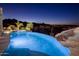 Stunning pool area featuring a spa, rock accents, and panoramic city views under the night sky at 15054 E Sundown Dr, Fountain Hills, AZ 85268