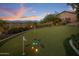 Backyard putting green featuring short flags, multiple holes, mountain views and professional golf clubs at 15054 E Sundown Dr, Fountain Hills, AZ 85268