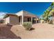 Spacious backyard featuring a covered patio and desert landscaping, perfect for low-maintenance outdoor living at 15429 W Ventura St, Surprise, AZ 85379