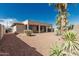 The backyard showcases a covered patio and low-maintenance desert landscaping, perfect for outdoor enjoyment at 15429 W Ventura St, Surprise, AZ 85379
