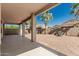 Covered patio overlooking a well-kept backyard with desert landscaping, offering a relaxing outdoor living space at 15429 W Ventura St, Surprise, AZ 85379