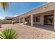 A covered patio enhances outdoor enjoyment in this backyard, featuring desert landscaping for low maintenance at 15429 W Ventura St, Surprise, AZ 85379