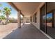 Expansive covered patio offers a comfortable area for outdoor entertaining and relaxation overlooking desert landscaping at 15429 W Ventura St, Surprise, AZ 85379