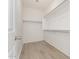 Walk-in closet offers ample storage with built in shelving and laminate flooring at 15429 W Ventura St, Surprise, AZ 85379
