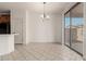 Dining area features tiled floors, chandelier and sliding glass door to patio at 15429 W Ventura St, Surprise, AZ 85379