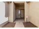Covered entrance to home featuring a neutral color palette, a window, and a lockbox on the front door at 15429 W Ventura St, Surprise, AZ 85379