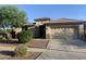 Charming single-story home with a two-car garage, desert landscaping, and a well-maintained front yard at 15429 W Ventura St, Surprise, AZ 85379