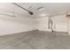 Spacious garage with concrete flooring and water heater at 15429 W Ventura St, Surprise, AZ 85379