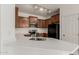 Kitchen with white countertops and stainless steel appliances, illuminated by track lights at 15429 W Ventura St, Surprise, AZ 85379