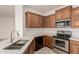 Well-equipped kitchen featuring stainless steel appliances, and stylish countertops at 15429 W Ventura St, Surprise, AZ 85379