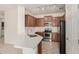 Kitchen with stainless steel appliances, a breakfast bar and ample cabinet space at 15429 W Ventura St, Surprise, AZ 85379