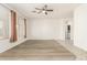 Bright, spacious living room featuring hardwood floors, large windows, and neutral walls providing an airy feel at 15429 W Ventura St, Surprise, AZ 85379