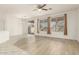 Open-concept living area featuring hardwood flooring, plenty of natural light, and access to a covered patio at 15429 W Ventura St, Surprise, AZ 85379