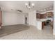 Bright open-concept living space with modern floors, breakfast bar and tile flooring at 15429 W Ventura St, Surprise, AZ 85379