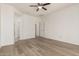 Spacious main bedroom featuring modern floors, ceiling fan and neutral color palette at 15429 W Ventura St, Surprise, AZ 85379