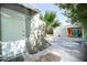 View of backyard with a shed, open garage, and a paved area, shaded by a tree at 1609 W Lewis Ave, Phoenix, AZ 85007
