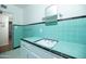 Bathroom features a sink with turquoise tiling and a mirror at 1609 W Lewis Ave, Phoenix, AZ 85007