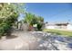 Long driveway leading to a backyard with a detached garage and palm tree at 1609 W Lewis Ave, Phoenix, AZ 85007