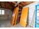 The interior of the garage with exposed ceiling joists, shelves, and other items at 1609 W Lewis Ave, Phoenix, AZ 85007