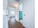 Hallway with doors to bathroom and bedroom, featuring wood floors and neutral walls at 1609 W Lewis Ave, Phoenix, AZ 85007