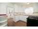 Kitchen features white cabinets, tile backsplash, and a range at 1609 W Lewis Ave, Phoenix, AZ 85007