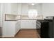 Kitchen features white cabinets, red backsplash, and a range at 1609 W Lewis Ave, Phoenix, AZ 85007