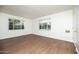 Bright living room with wood floors, neutral walls, and natural light from large windows at 1609 W Lewis Ave, Phoenix, AZ 85007