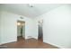 Living room with wood floors, neutral walls, and doorways to the bathroom and kitchen at 1609 W Lewis Ave, Phoenix, AZ 85007