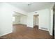 Open-concept living area with wood floors and archway leading to additional rooms at 1609 W Lewis Ave, Phoenix, AZ 85007