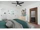 Bedroom with a bed, shelves, and adjacent tiled bathroom at 1621 W Mulberry Dr, Phoenix, AZ 85015