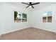 Carpeted bedroom features dual windows with views of the exterior at 1621 W Mulberry Dr, Phoenix, AZ 85015