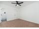 Empty bedroom with a ceiling fan and adjacent tiled bathroom at 1621 W Mulberry Dr, Phoenix, AZ 85015