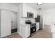 Updated kitchen with white cabinetry, stainless steel appliances, and stone countertops at 1621 W Mulberry Dr, Phoenix, AZ 85015