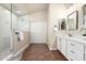 Bright bathroom with seamless glass shower and vanity with marble countertop at 17649 N Vera Cruz Ave, Maricopa, AZ 85139