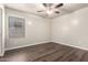 Simple bedroom features laminate floors and a ceiling fan at 17649 N Vera Cruz Ave, Maricopa, AZ 85139