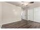 Bright bedroom with hardwood floors, ceiling fan, and sliding-door closet at 17649 N Vera Cruz Ave, Maricopa, AZ 85139