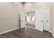 Empty room with hardwood floors and double doors at 17649 N Vera Cruz Ave, Maricopa, AZ 85139