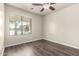 Well-lit bedroom with hardwood floors and window at 17649 N Vera Cruz Ave, Maricopa, AZ 85139
