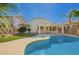 Inviting backyard featuring a private pool, artificial turf, and a covered patio, perfect for outdoor entertaining at 17649 N Vera Cruz Ave, Maricopa, AZ 85139