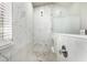 Shower features white marble tiling, glass enclosure, pebble floor, and a built-in shelf at 17649 N Vera Cruz Ave, Maricopa, AZ 85139