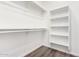 Walk-in closet with shelving and laminate flooring at 17649 N Vera Cruz Ave, Maricopa, AZ 85139