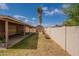 Backyard featuring block fence, shed, grass, covered patio and some landscaping at 1814 N 89Th Ave, Phoenix, AZ 85037