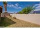 Spacious backyard featuring block fence, storage shed, grass and some landscaping at 1814 N 89Th Ave, Phoenix, AZ 85037